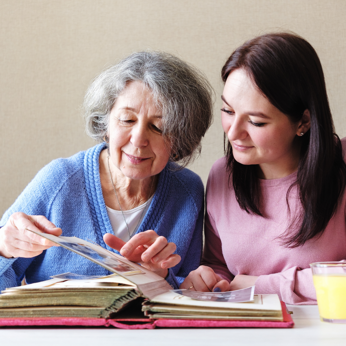 Senior woman and relative looking at photos