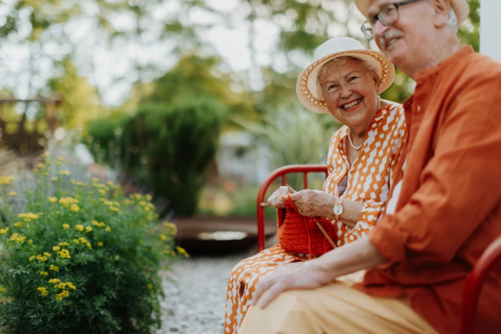 Senior couple sitting on a bench in a garden